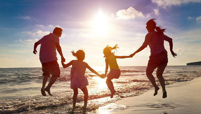 family travelling on a beach